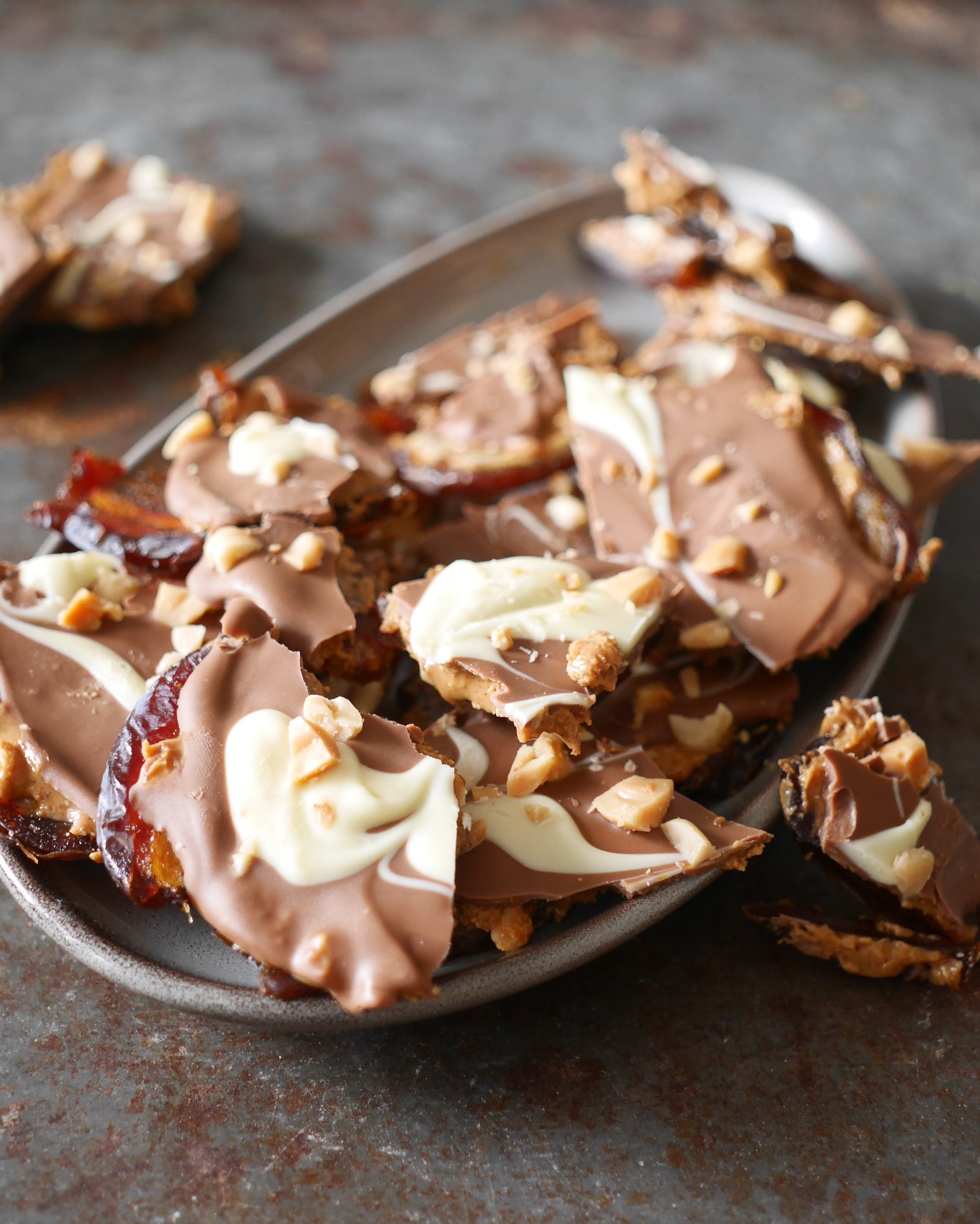 Van natural_nuts kreeg ik een heerlijk pakketje. Daarin zaten onder andere medjoul dadels en pinda’s. Dus.. dat kon maar 1 ding betekenen. Ik ging de date bark maken oftewel een dadel reep. Moeilijk is het niet, wel héél lekker.

Dit heb je nodig; 
- 12 medjoul dadels natural_nuts 
- Pindakaas, ik gebruikte 2 eetlepels. (100% pindakaas met stukjes)
- 80 gram melkchocolade
- 20 gram witte chocolade (optioneel) 
- handvol in stukjes gehakte zoute pinda’s natural_nuts 

Ontpit de dadels en leg ze open gevouwen tegen elkaar aan op een bakpapier. 4 rijtjes van 3 zeg maar, zodat je een groot vlak krijgt. 
Leg daarop weer een vel bakpapier en rol er met een deegroller overheen. Geen deegroller in huis? Platdrukken met een glad werkt ook. Je hebt nu 1 grote plak dadel.
Smeer die plak in met de pindakaas.
Smelt de melkchocolade en verdeel zodra het gesmolten is over de pindakaas. 
Optioneel; Smelt de witte chocolade en trek lijnen over de melk chocolade. Wil je een leuk effect? Trek dan met een satéprikker lijnen door de witte chocolade. 
Strooi de gehakte zoute pinda’s over de gesmolten chocolade en zet voor minimaal 2 uur in de koelkast. Daarna kan je de reep in stukken breken. Bewaar wel in de koelkast.

Heb jij deze “reep” al eens gemaakt?

Mooie dag vandaag! 🌸
Liefs, Daniëlle

Leuk voor jullie! Met de code; DANIELLENN krijg je 10% korting op je bestelling bij natural_nuts 🩷